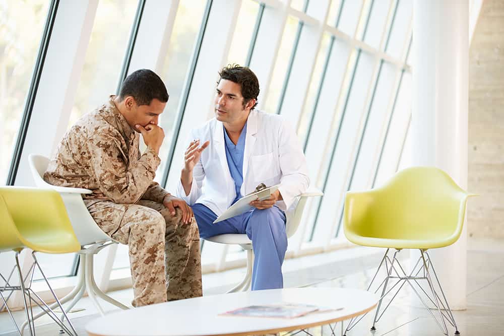 doctor counseling a soldier suffering from PTSD